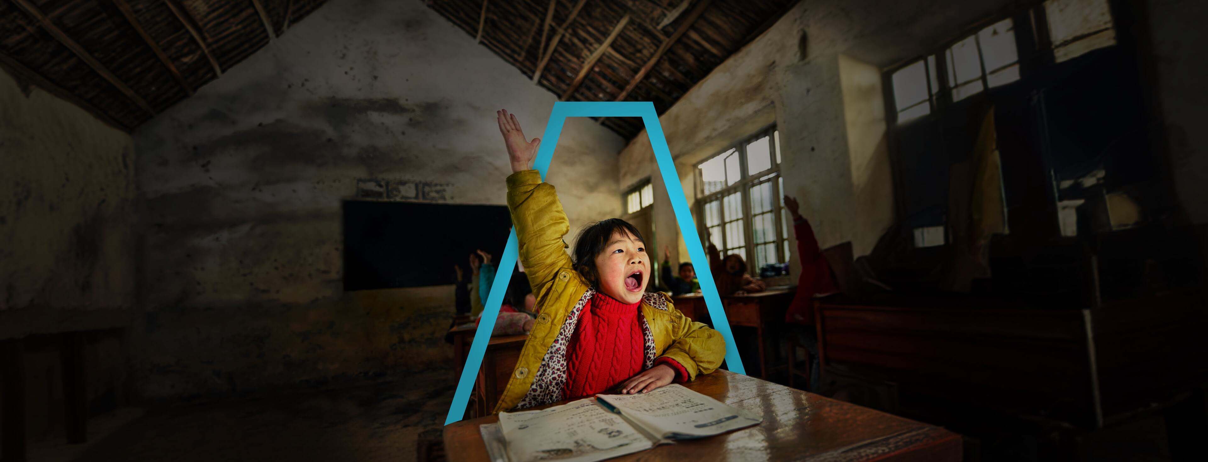 A school girl eagerly raising her hand in class