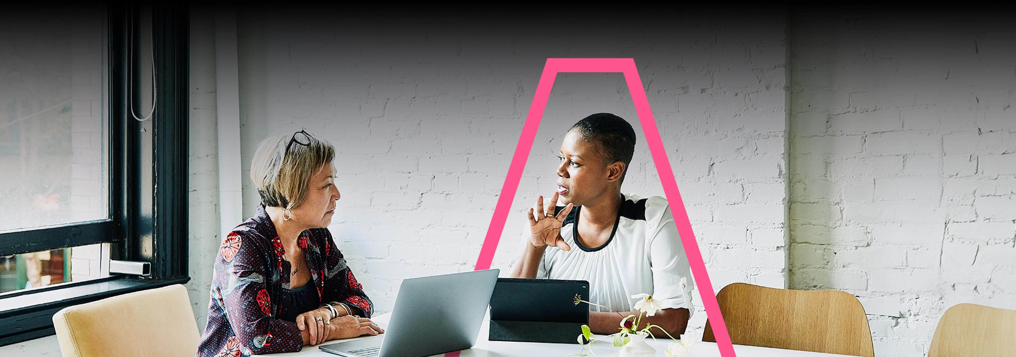 Two women having a discusion in a meeting room